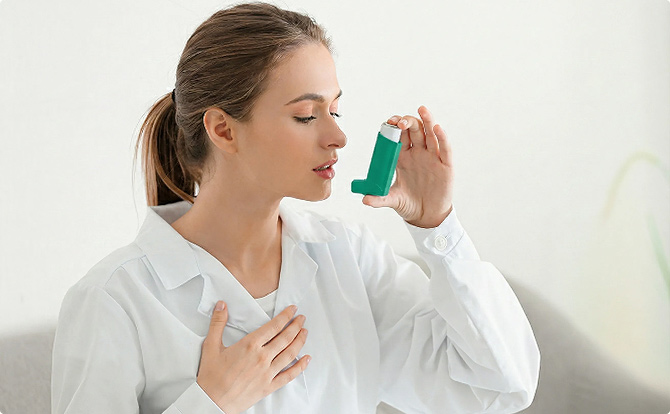 Junge Frau verwendet Asthmaspray