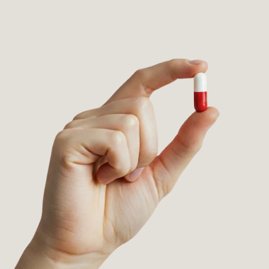 Female hand holding a capsule