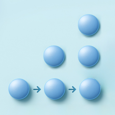Calendar showing pill dosage schedule, with a pack of pills on top.