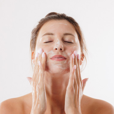 A woman cleansing her skin.