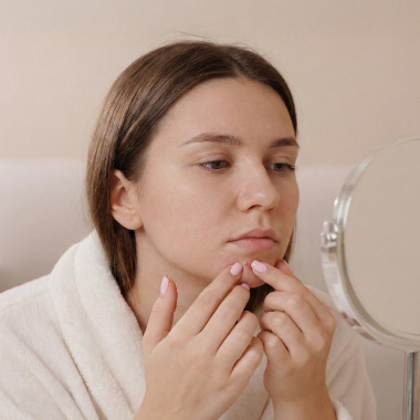 A close-up of a woman with a pimple