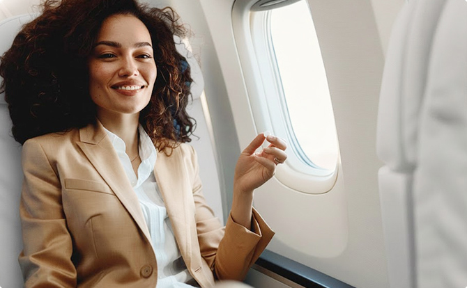 Woman taking tablets on an airplane